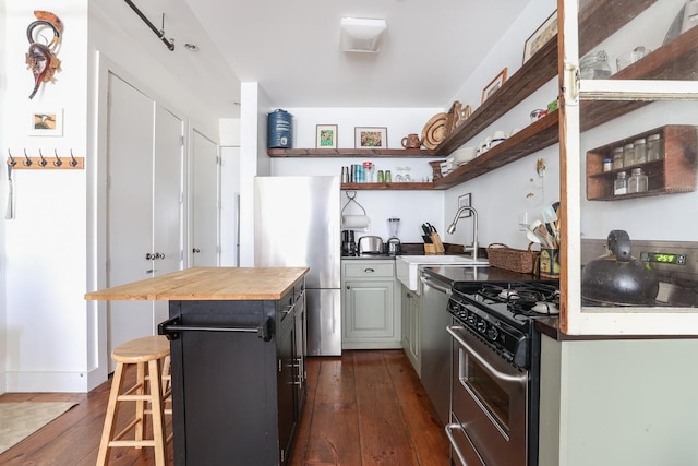 940 Fulton St Unit 3B, New York City, NY 11238 - kitchen with open shelves, black gas stove, butcher block counters, freestanding refrigerator, and dark wood-type flooring