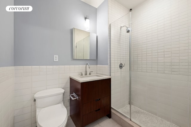 415 Greenwich St Unit 5H, New York City, NY 10013 - full bathroom with tile walls, vanity, a tile shower, toilet, and wainscoting