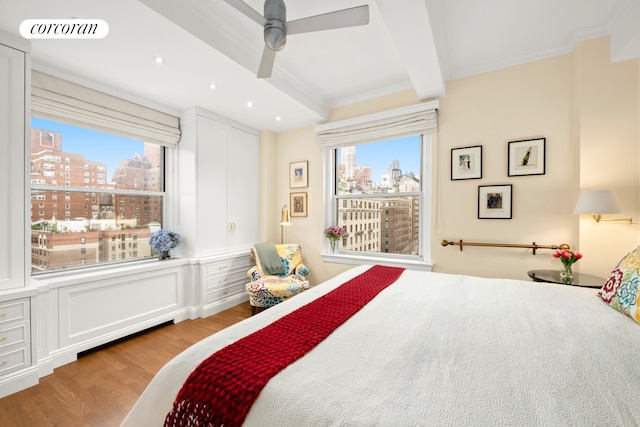 135 E 74th St Unit 11Bc, New York City, NY 10021 - bedroom featuring a city view, ornamental molding, light wood finished floors, recessed lighting, and beam ceiling