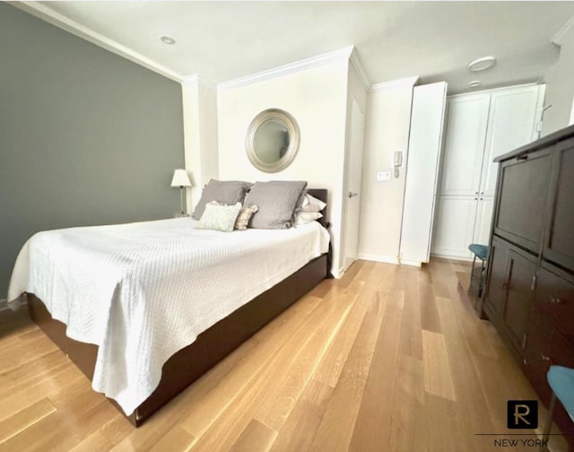 233 E 69th St Unit 3-O, New York City, NY 10021 - bedroom with crown molding and light wood-style flooring