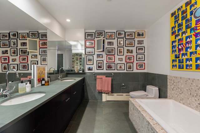 351 W Broadway Unit 4, New York City, NY 10013 - full bath with baseboard heating, tile patterned flooring, double vanity, a bath, and tile walls