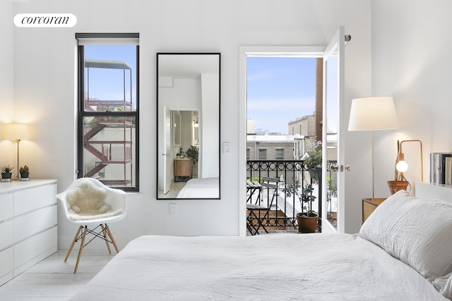 138 Broadway Unit 5G, New York City, NY 11211 - bedroom featuring multiple windows and wood finished floors
