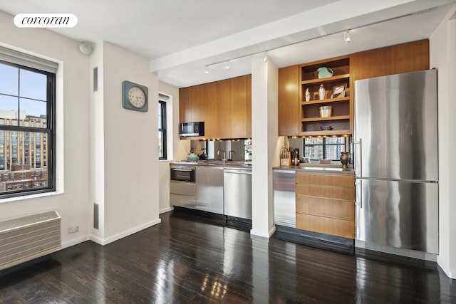 200 E 16th St Unit 14H, New York City, NY 10003 - kitchen featuring appliances with stainless steel finishes, track lighting, modern cabinets, and brown cabinets