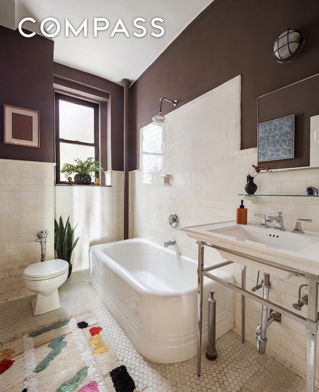 270 Riverside Dr Unit 2C, New York City, NY 10025 - full bathroom with tile walls, toilet, a bathtub, tile patterned floors, and wainscoting