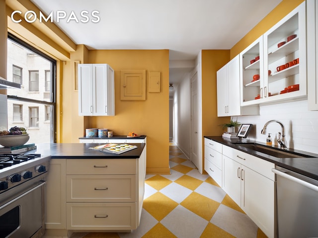 270 Riverside Dr Unit 2C, New York City, NY 10025 - kitchen with light floors, stainless steel appliances, a sink, and dark countertops