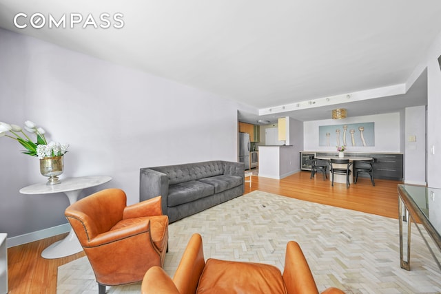 40 W 116th St Unit B302, New York City, NY 10026 - living area featuring light wood-style flooring and baseboards