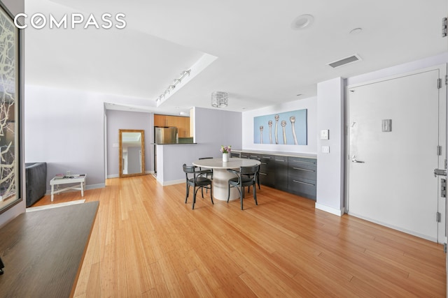 40 W 116th St Unit B302, New York City, NY 10026 - dining area with light wood-type flooring and baseboards