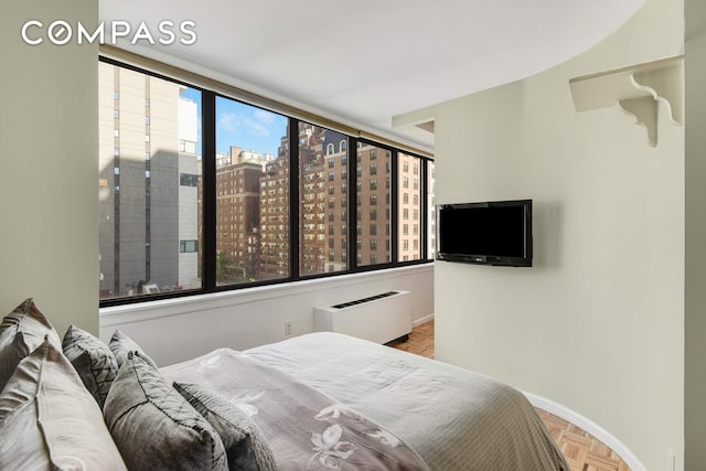 455 E 86th St Unit 8D, New York City, NY 10028 - bedroom featuring a wall mounted AC and baseboards
