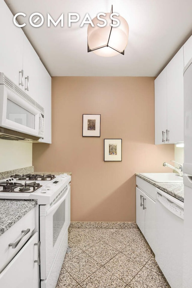 455 E 86th St Unit 8D, New York City, NY 10028 - kitchen with white appliances, a sink, light countertops, and white cabinetry