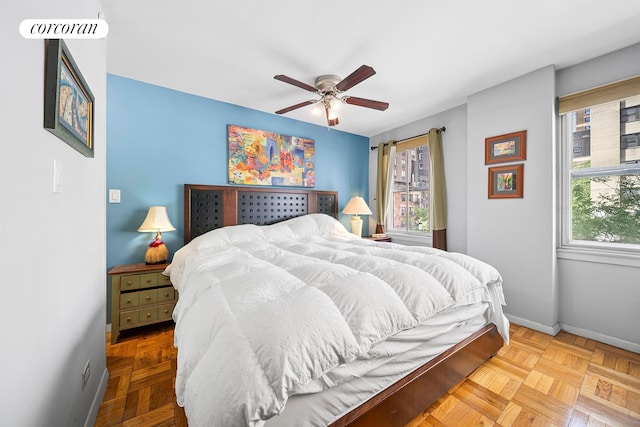 201 E 37th St Unit 4F, New York City, NY 10016 - bedroom featuring multiple windows, baseboards, and a ceiling fan