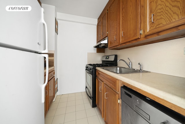 201 E 37th St Unit 4G, New York City, NY 10016 - kitchen featuring stainless steel appliances, under cabinet range hood, brown cabinets, a sink, and light countertops