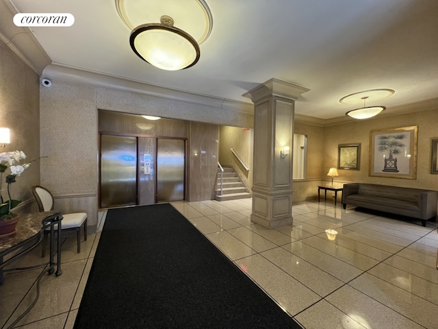 201 E 37th St Unit 4Fg, New York City, NY 10016 - lobby featuring crown molding, stairs, and a wainscoted wall
