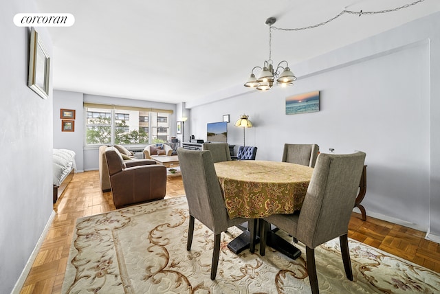 201 E 37th St Unit 4Fg, New York City, NY 10016 - dining room featuring a chandelier and baseboards