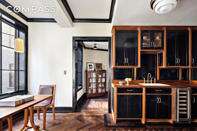 211 Elizabeth St Unit 3S, New York City, NY 10012 - bar area featuring beverage cooler, ornamental molding, a sink, and baseboards