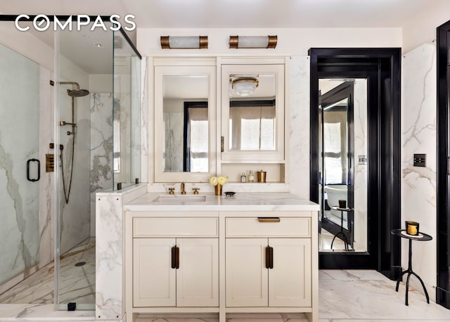 211 Elizabeth St Unit 3S, New York City, NY 10012 - full bathroom featuring a marble finish shower, vanity, and marble finish floors