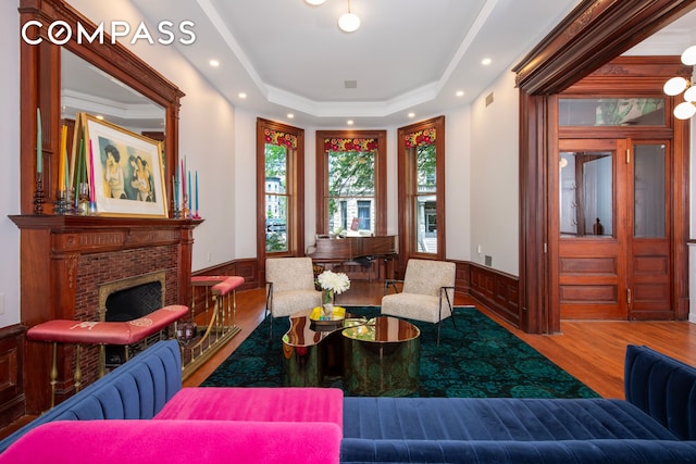 430 W 147th St, New York City, NY 10031 - living area with wood finished floors, wainscoting, a raised ceiling, recessed lighting, and a brick fireplace