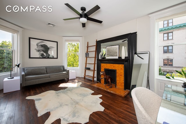 430 W 147th St, New York City, NY 10031 - living area with hardwood / wood-style floors, a ceiling fan, a fireplace, and healthy amount of natural light