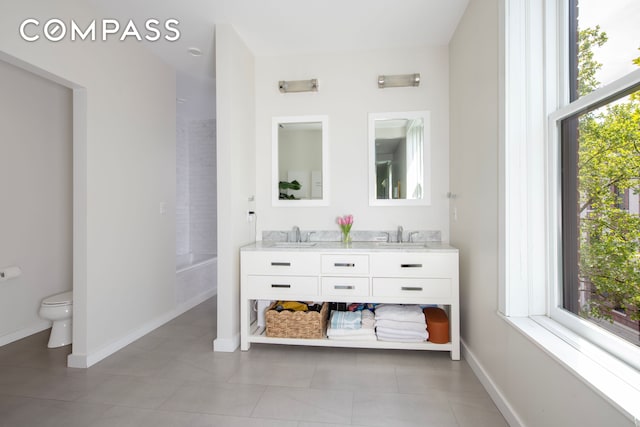 430 W 147th St, New York City, NY 10031 - full bath featuring double vanity, toilet, baseboards, and tile patterned flooring