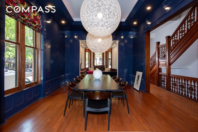 430 W 147th St, New York City, NY 10031 - dining room featuring wood finished floors, crown molding, healthy amount of natural light, stairway, and a decorative wall
