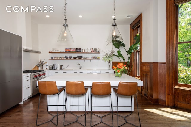 430 W 147th St, New York City, NY 10031 - kitchen with appliances with stainless steel finishes, light countertops, open shelves, dark wood-style floors, and white cabinets