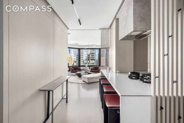 301 W 57th St Unit 36C, New York City, NY 10019 - kitchen featuring wall chimney range hood and wallpapered walls