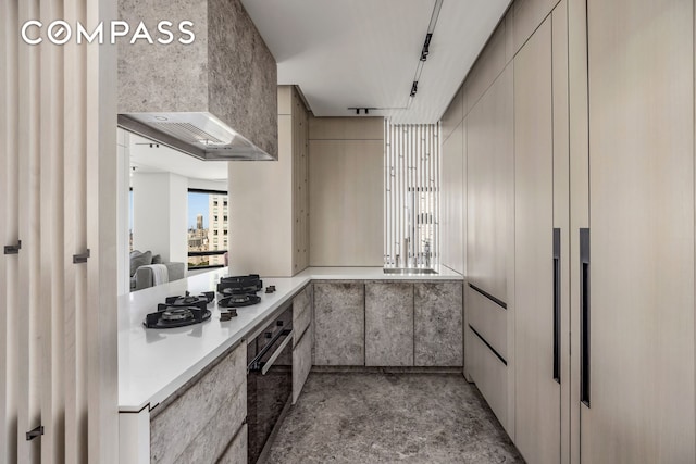 301 W 57th St Unit 36C, New York City, NY 10019 - kitchen featuring black oven, white gas stovetop, light countertops, modern cabinets, and concrete flooring