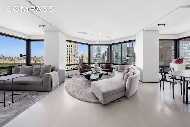301 W 57th St Unit 36C, New York City, NY 10019 - living room featuring a skyline view and wood finished floors