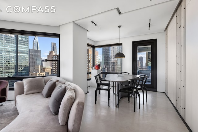 301 W 57th St Unit 36C, New York City, NY 10019 - dining area featuring finished concrete floors and a view of skyline