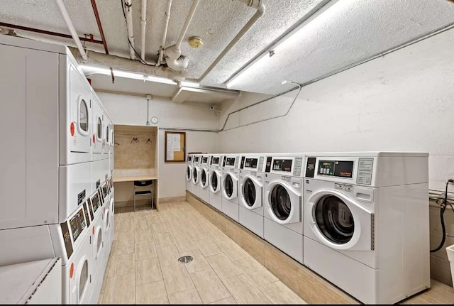 35 E 38th St Unit 3C, New York City, NY 10016 - community laundry room with estacked washer and dryer, washing machine and dryer, and a textured ceiling