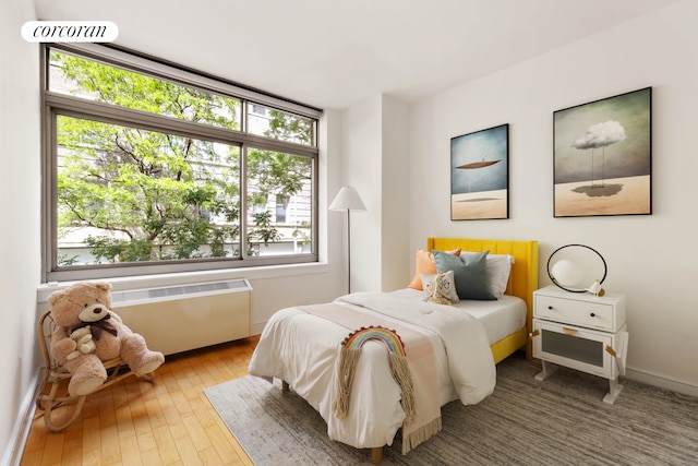 99 Jane St Unit 2J, New York City, NY 10014 - bedroom with radiator, hardwood / wood-style floors, and baseboards