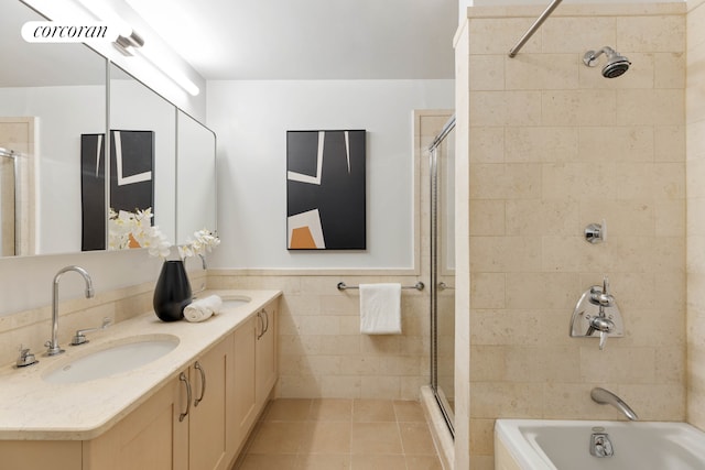 99 Jane St Unit 2J, New York City, NY 10014 - full bath featuring tiled shower, tile walls, double vanity, a bath, and tile patterned flooring