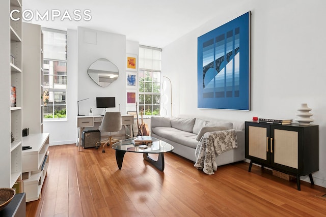 184 Kent Ave Unit D101, New York City, NY 11249 - living area with an office area, healthy amount of natural light, and wood finished floors