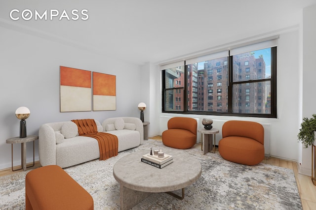 35 E 38th St Unit 12B, New York City, NY 10016 - living room with wood finished floors and a city view