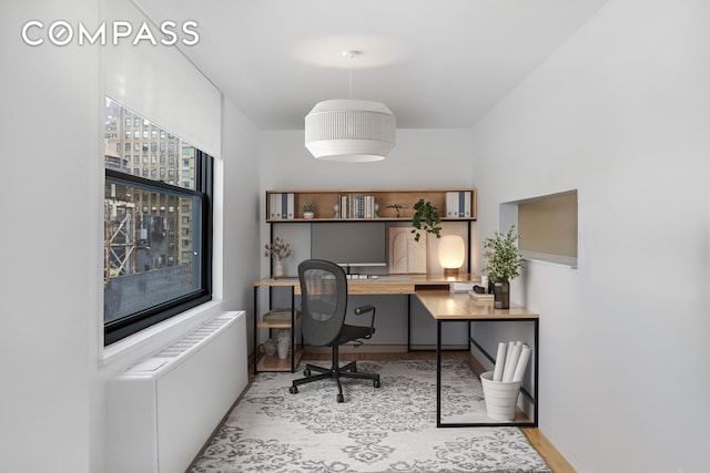 35 E 38th St Unit 12B, New York City, NY 10016 - office space featuring built in desk, wood finished floors, and radiator