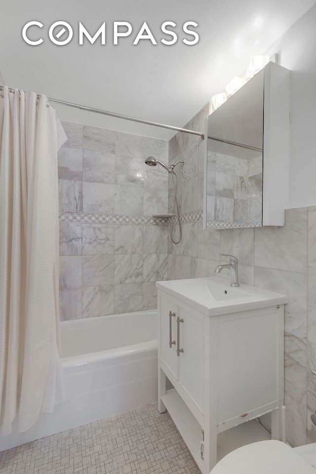 35 E 38th St Unit 12B, New York City, NY 10016 - full bathroom featuring tile walls, shower / bath combo with shower curtain, vanity, and backsplash