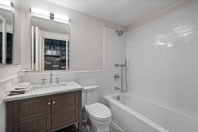 146 St Johns Place, New York City, NY 11217 - full bath with tile walls, toilet, tiled shower / bath combo, vanity, and wainscoting