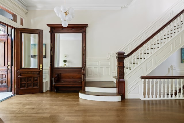146 St Johns Place, New York City, NY 11217 - entryway with stairway, ornamental molding, a chandelier, wood finished floors, and a decorative wall