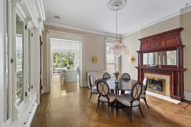 146 St Johns Place, New York City, NY 11217 - dining room featuring ornamental molding, a fireplace, a chandelier, and baseboards