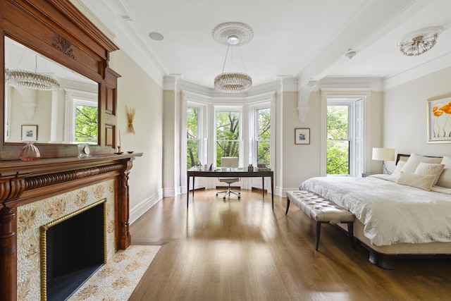 146 St Johns Place, New York City, NY 11217 - bedroom featuring multiple windows, an office area, baseboards, wood finished floors, and crown molding