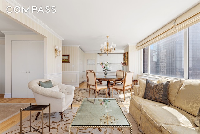 322 W 57th St Unit 33U, New York City, NY 10019 - living room featuring wood finished floors, ornamental molding, a chandelier, and a decorative wall