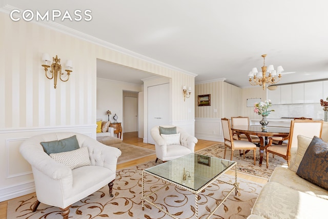 322 W 57th St Unit 33U, New York City, NY 10019 - living room with light wood-style flooring, a chandelier, crown molding, a decorative wall, and a wainscoted wall