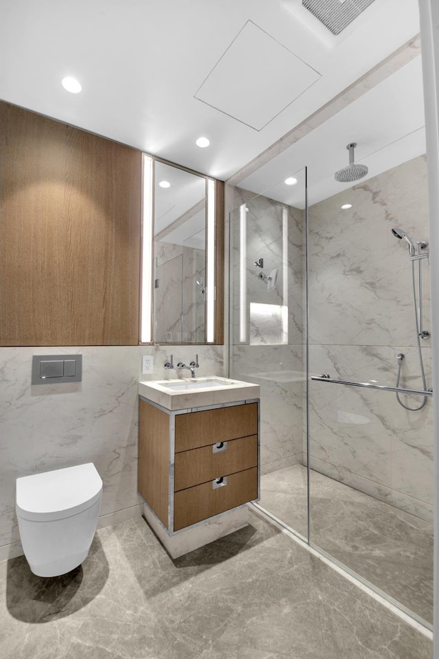40 Bleecker St Unit 3H, New York City, NY 10012 - bathroom with a marble finish shower, vanity, tile walls, toilet, and recessed lighting