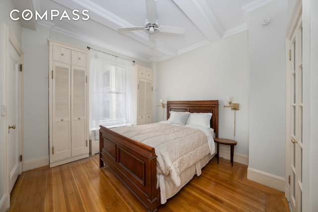 1060 Park Ave Unit 3Ab, New York City, NY 10128 - bedroom with baseboards, light wood-type flooring, two closets, beam ceiling, and crown molding