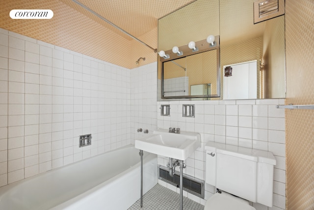 360 E 72nd St Unit C2003, New York City, NY 10021 - bathroom featuring tile walls, toilet, bathtub / shower combination, and tile patterned flooring