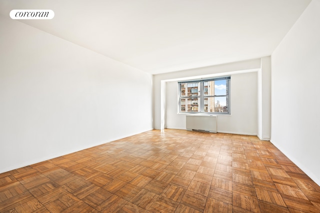 360 E 72nd St Unit C2003, New York City, NY 10021 - spare room featuring radiator and baseboards