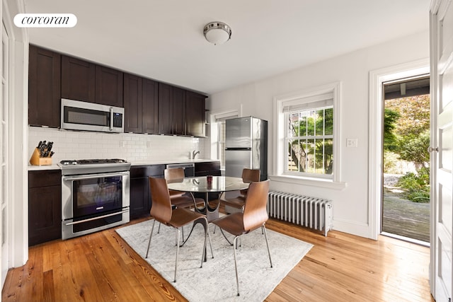 151 Herkimer St, New York City, NY 11216 - dining space with radiator heating unit, light wood finished floors, and baseboards