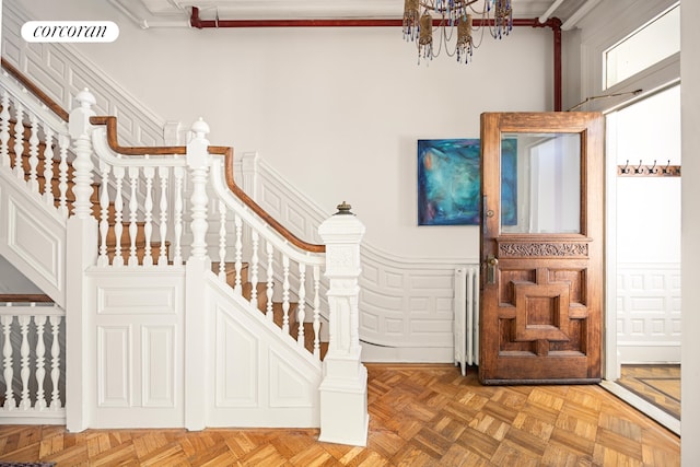 151 Herkimer St, New York City, NY 11216 - entryway with a chandelier, crown molding, radiator heating unit, and stairs