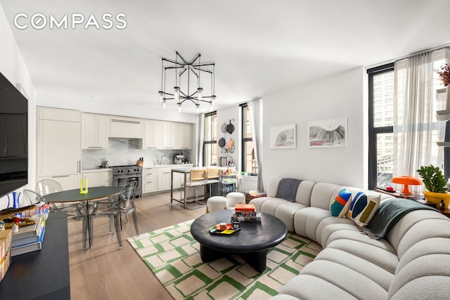 76 Schermerhorn St Unit 4C, New York City, NY 11201 - living room with a chandelier and light wood finished floors