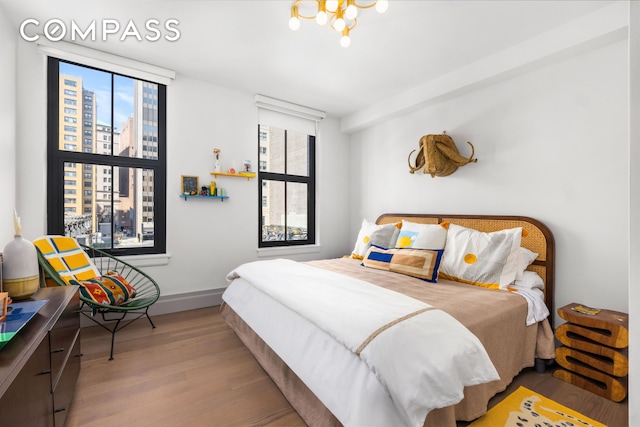 76 Schermerhorn St Unit 4C, New York City, NY 11201 - bedroom featuring wood finished floors, baseboards, and a city view