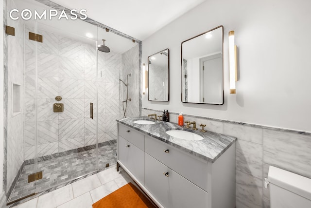 76 Schermerhorn St Unit 4C, New York City, NY 11201 - bathroom featuring a shower stall, double vanity, toilet, and tile patterned flooring